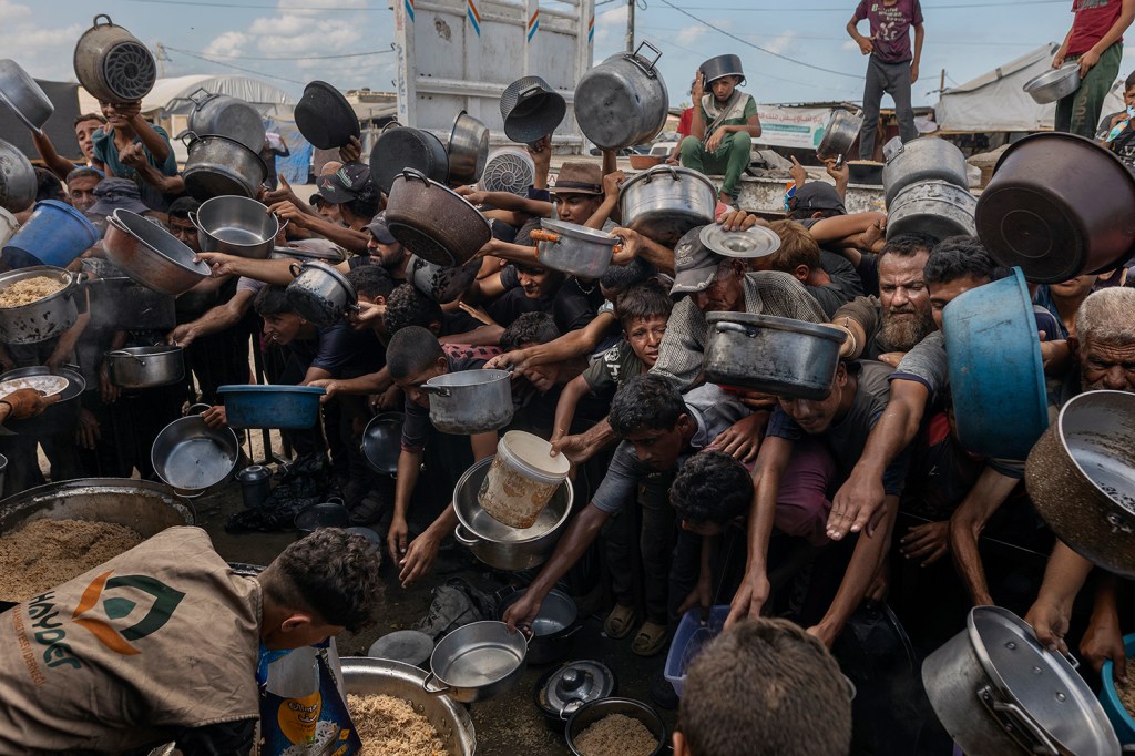 Palestinians at Al-Mawasi displacement camp wait for a meal. Local charity kitchens were one of the only food sources for many of Gaza’s displaced. Khan Younis, Gaza Strip, 21 September 2025.