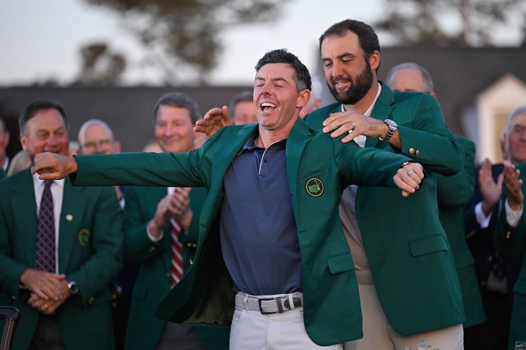 scottie scheffler gives rory mcilroy the masters green jacket at augusta 2025