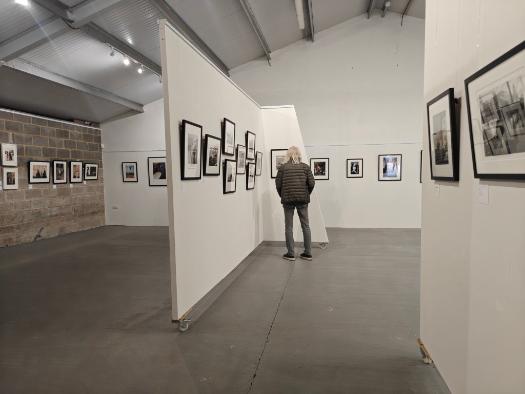 exhibition view at farleys house, black and white photos hanging on a wall
