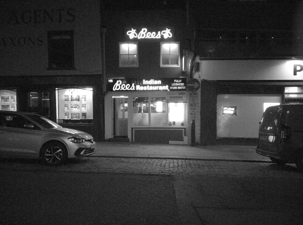 Flashback ONE35 camera sample black and white, street scene with a shop at night