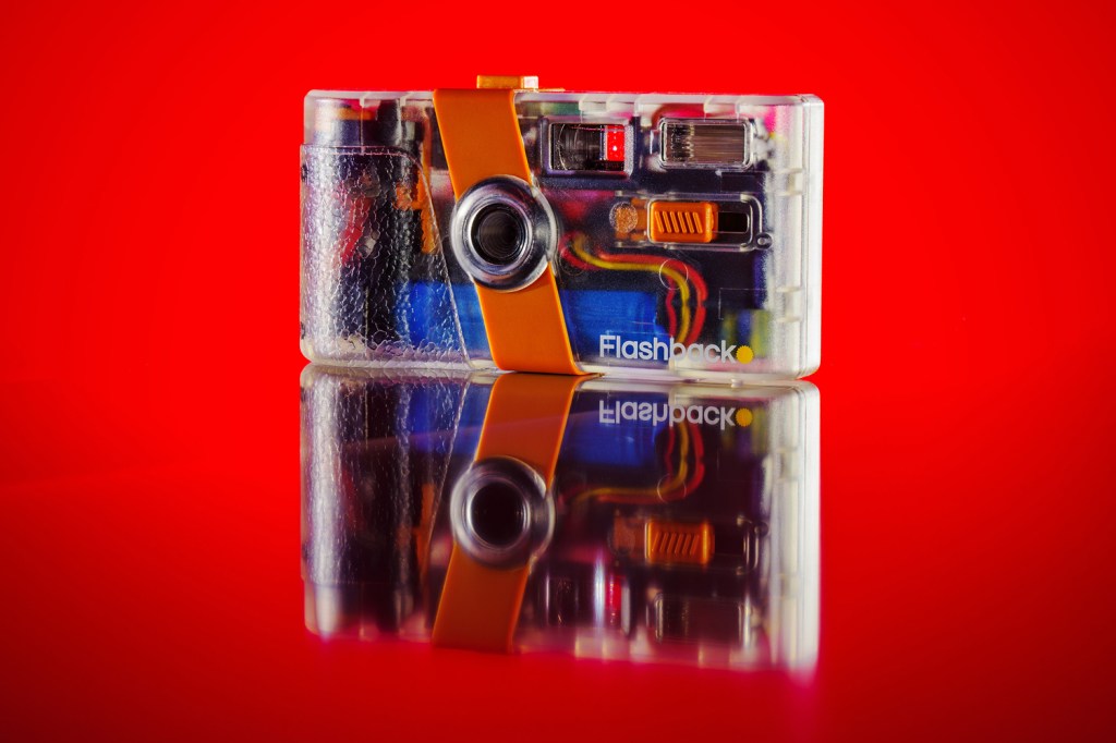 Flashback ONE35 camera against red background, front view