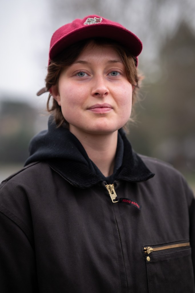 Portrait of a person wearing a black hooded top