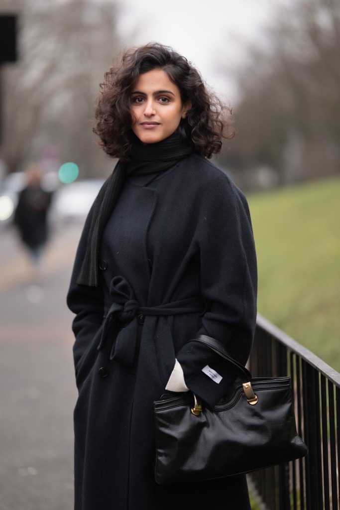 Portrait of a person wearing a black coat