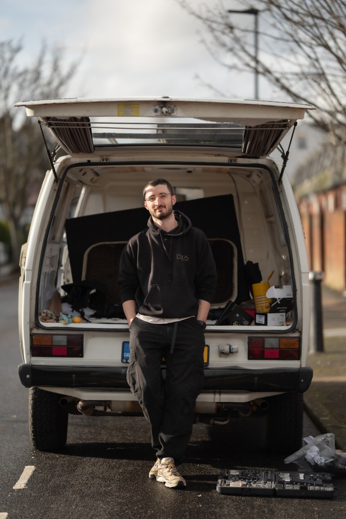 Portrait of a person standing in front of a utility van