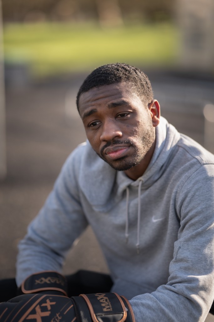 Portrait of a person wearing a grey hooded top