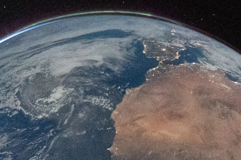 Detail of Hello, World, highlighting the city lights of Spain and the Aurora Borealis