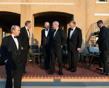 a group of men dressed in black formal