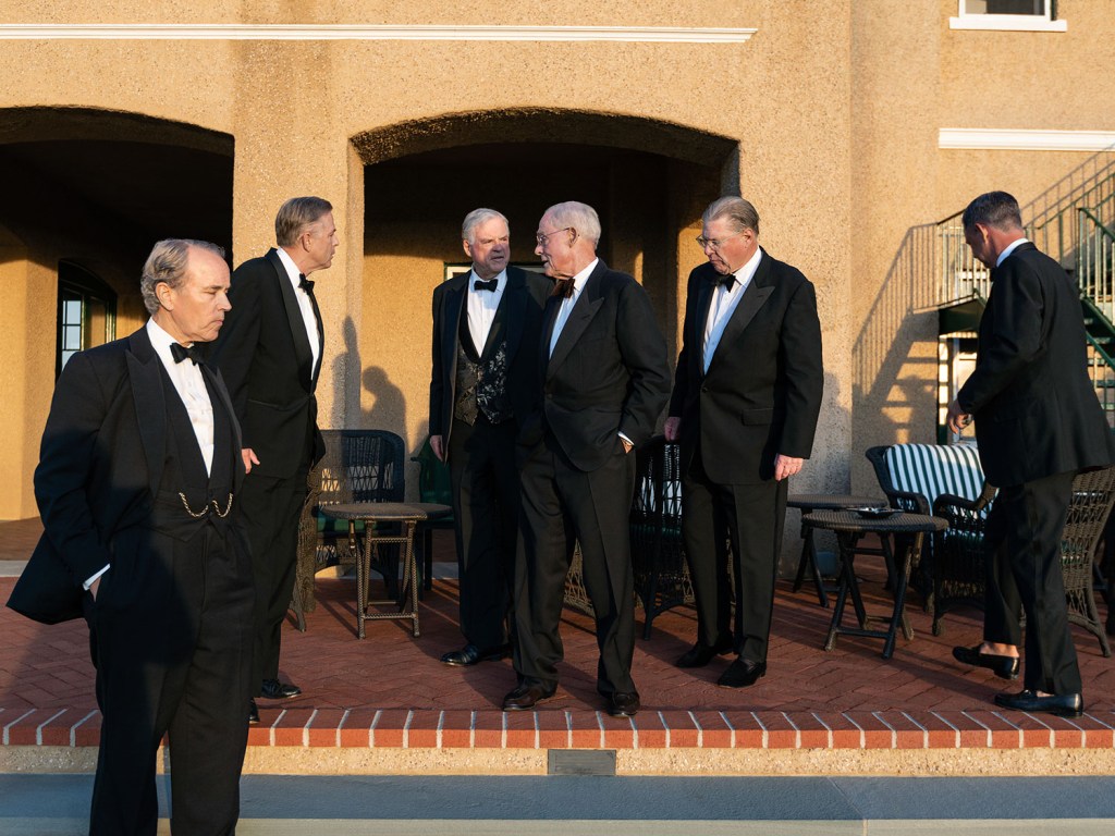 a group of men dressed in black formal