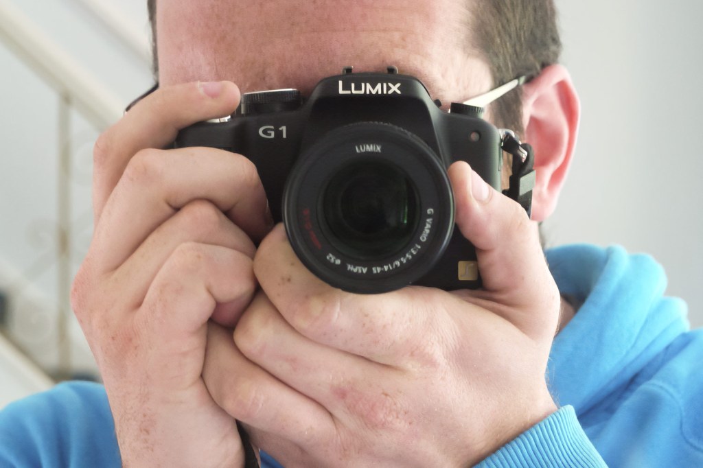 Panasonic Lumix G1 in hand. Photo Joshua Waller (Single use only)