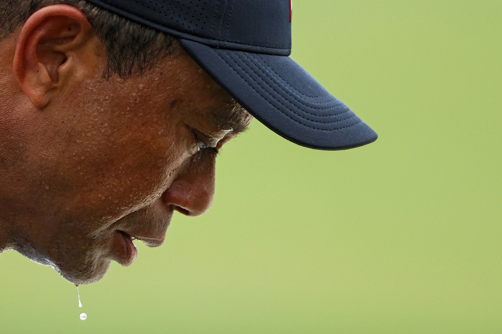 AUGUSTA, GEORGIA - APRIL 06: Sweat drips from the chin of Tiger Woods of the United States as he plays during the first round of the 2023 Masters Tournament at Augusta National Golf Club on April 06, 2023 in Augusta, Georgia.