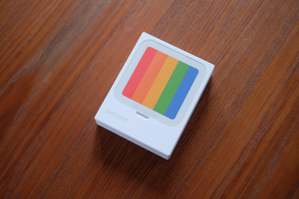 Photograph of Polaroid Hi-Print 3x3 printer on table showing generic coloured disply