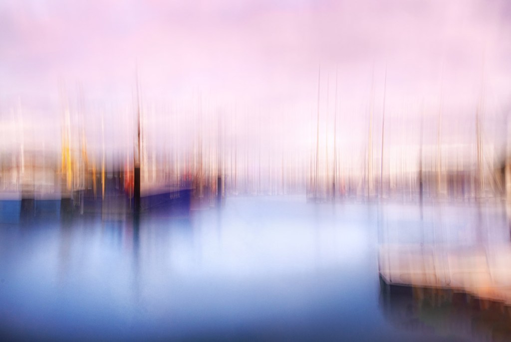 intentional camera movement blur landscape of boats in  a harbour