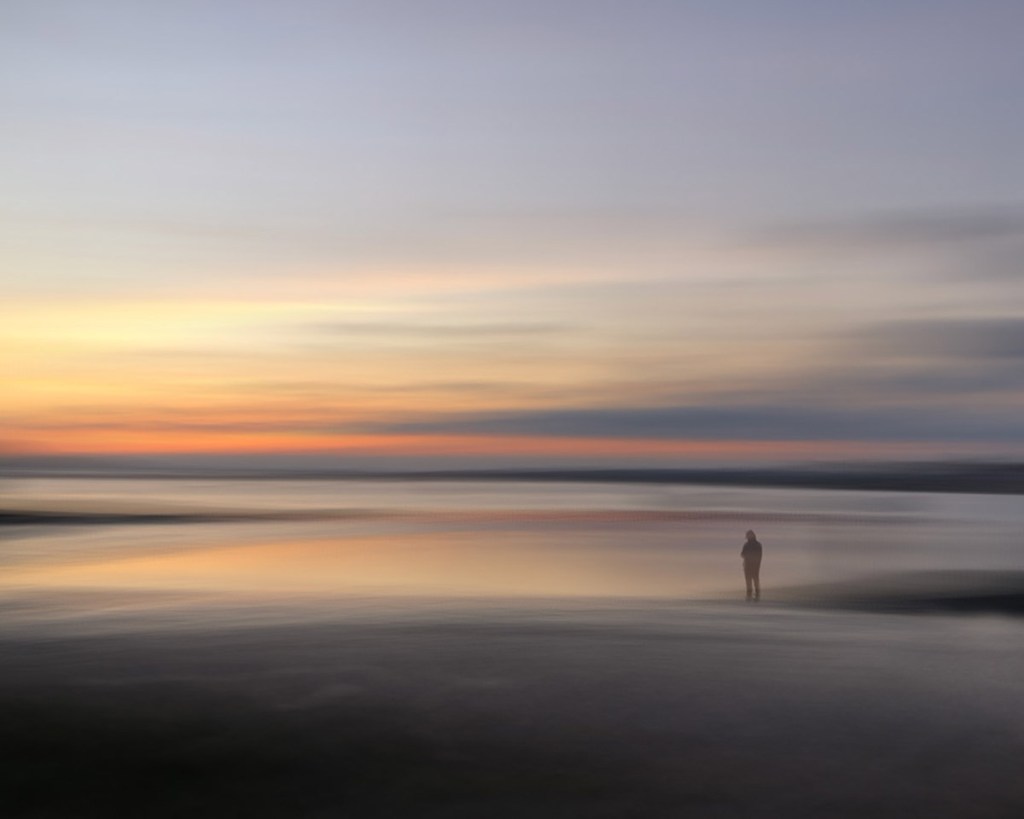 landscape scene at sunset with one person in the midground