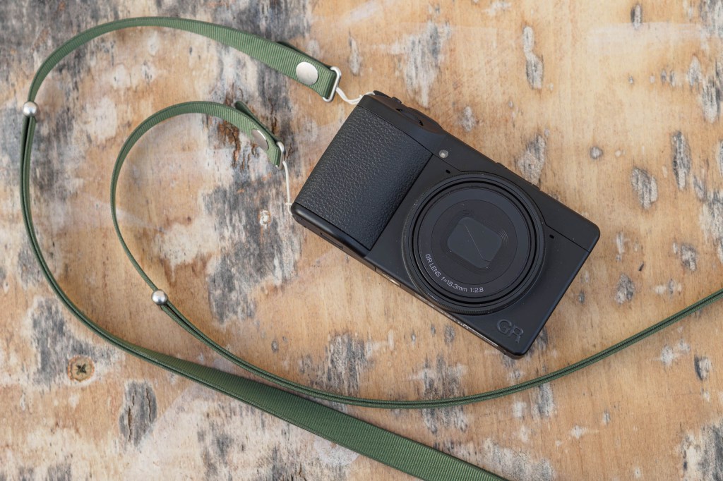 Ricoh GR IV Monochrome fitted with neckstrap.