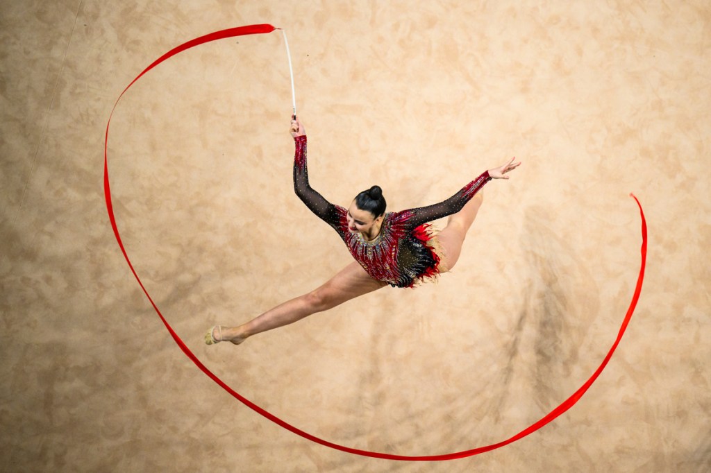 Image of gymnast on floor with ribbon