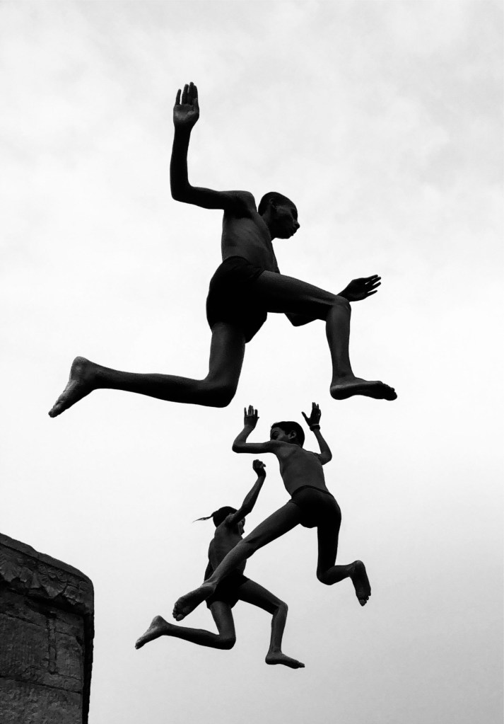 three boys jumping captured midair