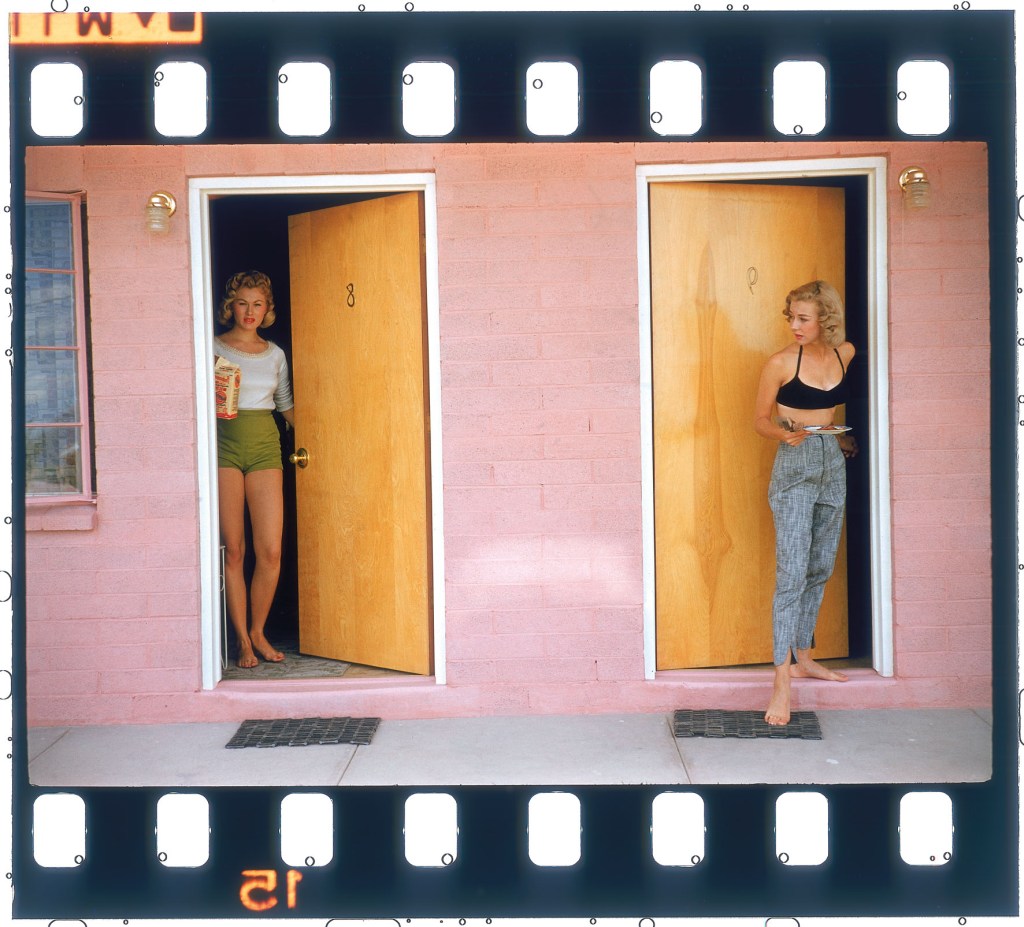 Two women stand in two doorways