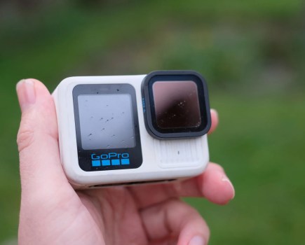 Man's hand holding GoPro Hero 13 Black in white colorway