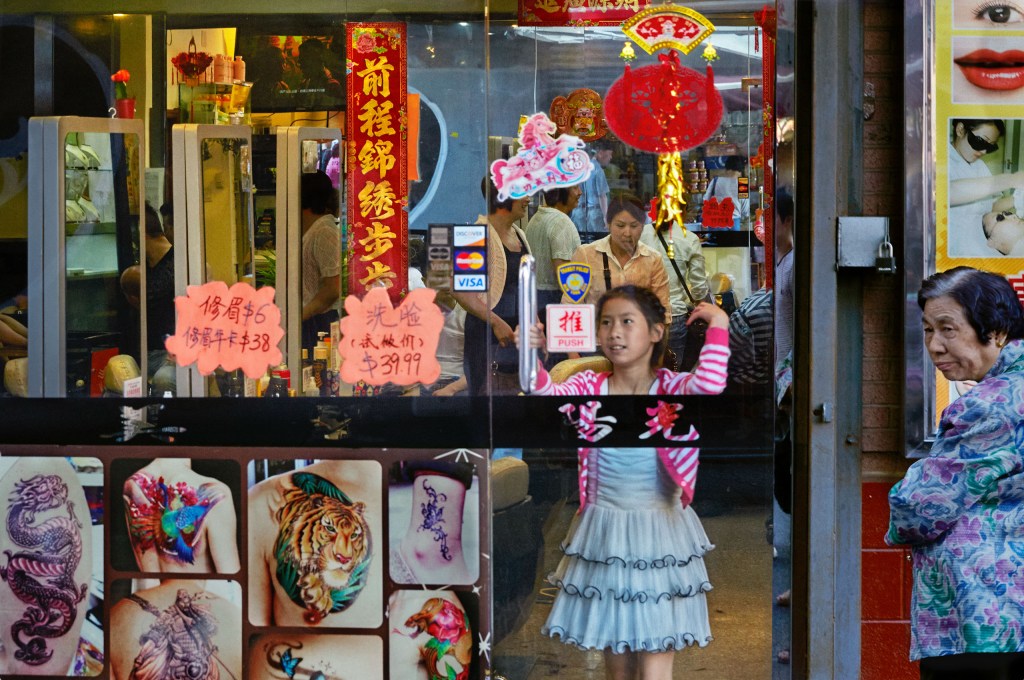 girl standing at the window of a shop