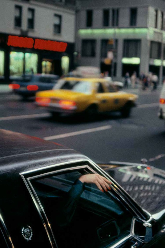 blurry image of yellow cab driving by