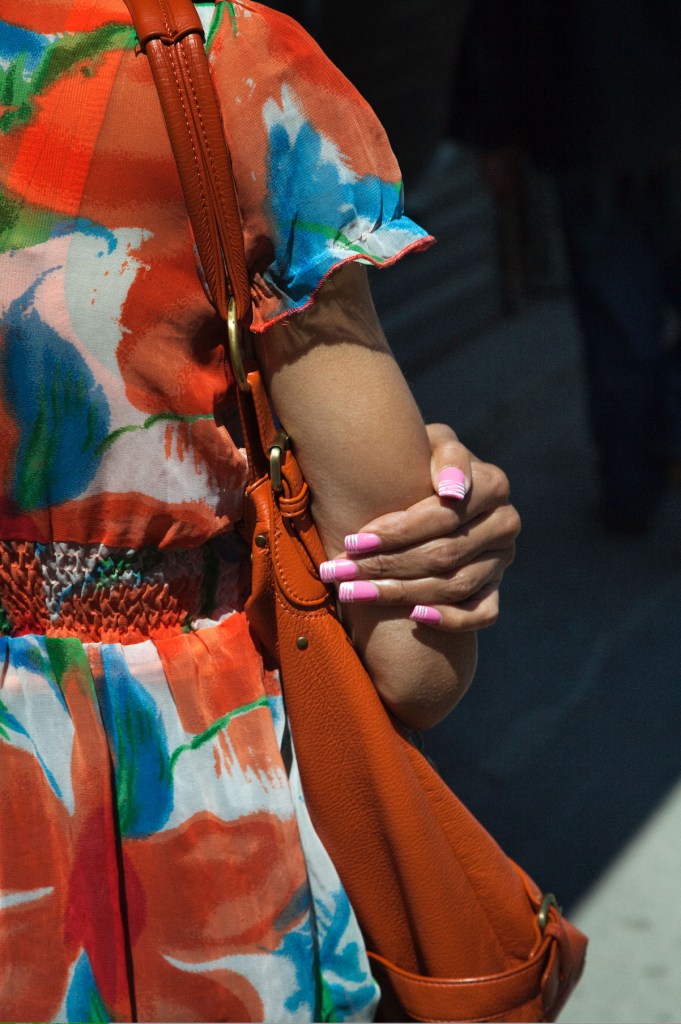 back of woman clutching her arm