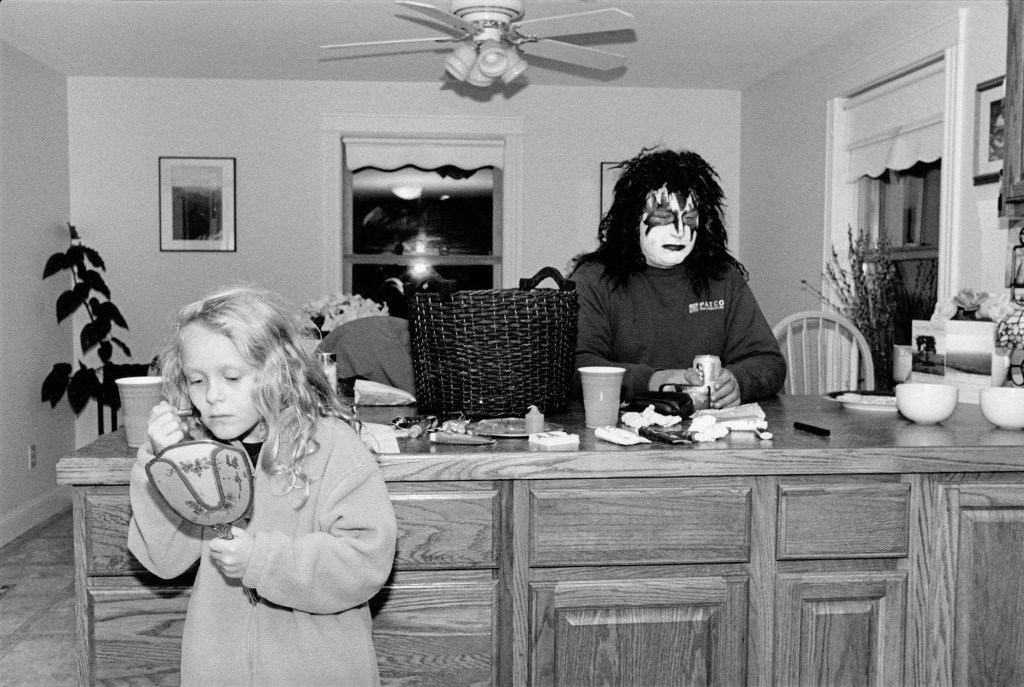 black and white photo of two people putting on Halloween makeup