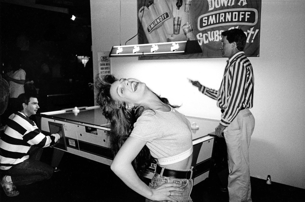 black and white photo of a three people infront of a pool table