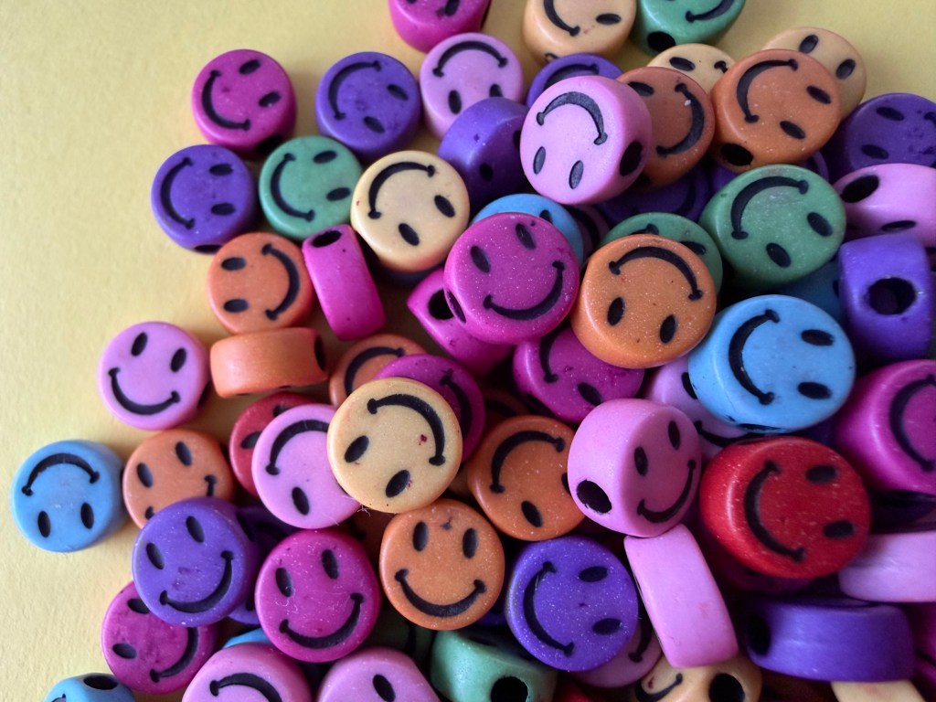 coloured beads on a yellow background