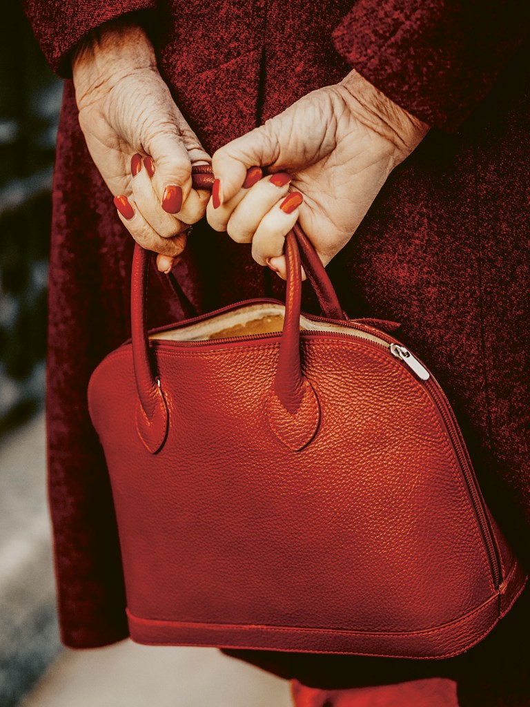 hands holding a red bag
