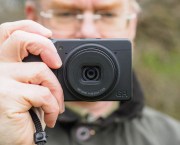 Man holding Ricoh GR IV Monochrome compact cameras