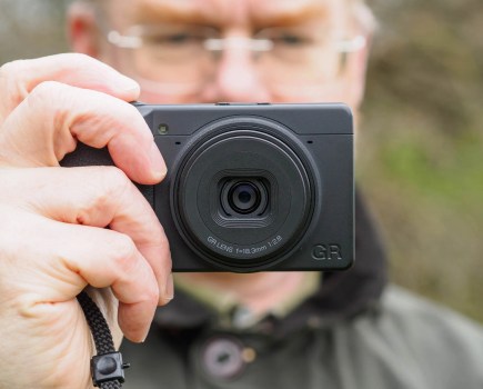 Man holding Ricoh GR IV Monochrome compact cameras