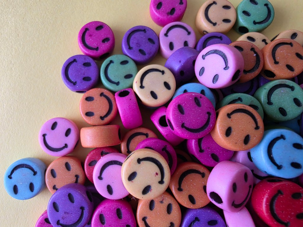 coloured beads on a yellow background