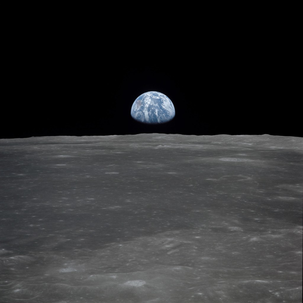 Apollo 11 Mission image - View of moon limb, with Earth on the horizon, Mare Smythii Region