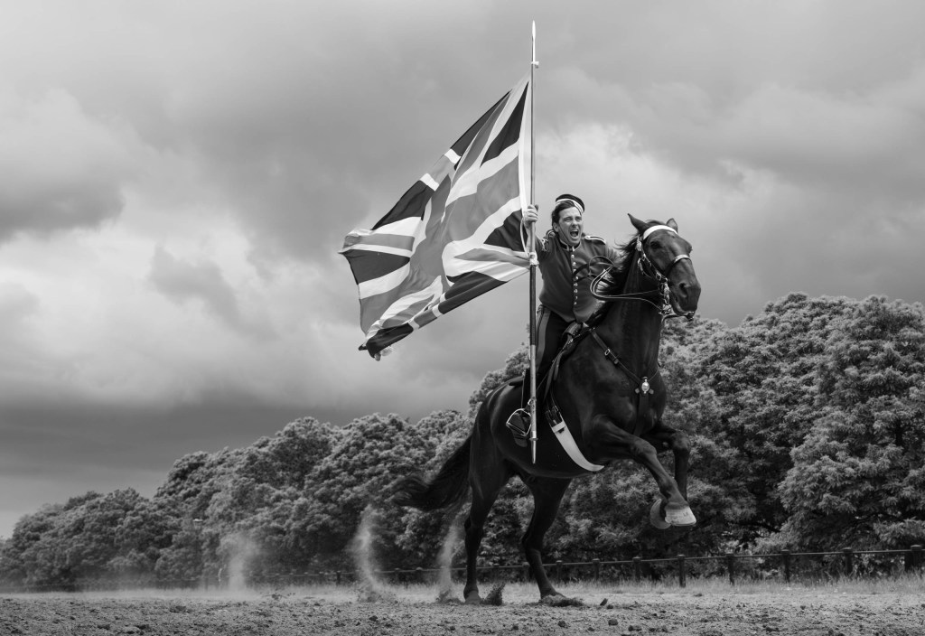black and white photo of soldier on horse