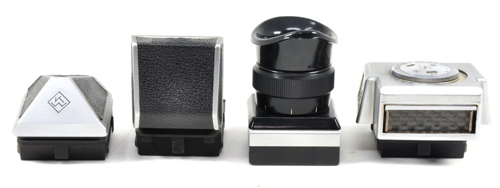 The four viewfinders produced for Praktina cameras, left to right: eye-level prism, waist-level, high magnification and metered prism