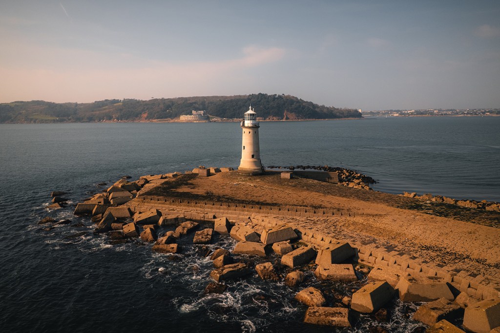 drone photo of a lighthouse in the landscape
