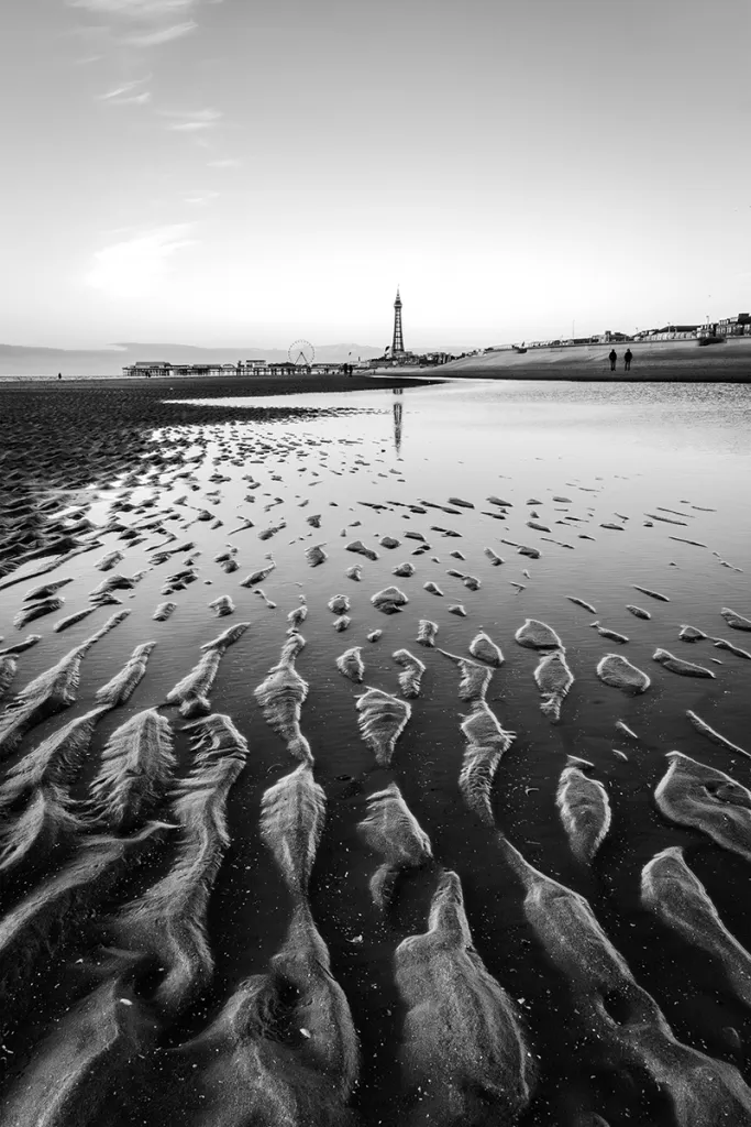 black and white photo of ripples in the sand at blackpool beach