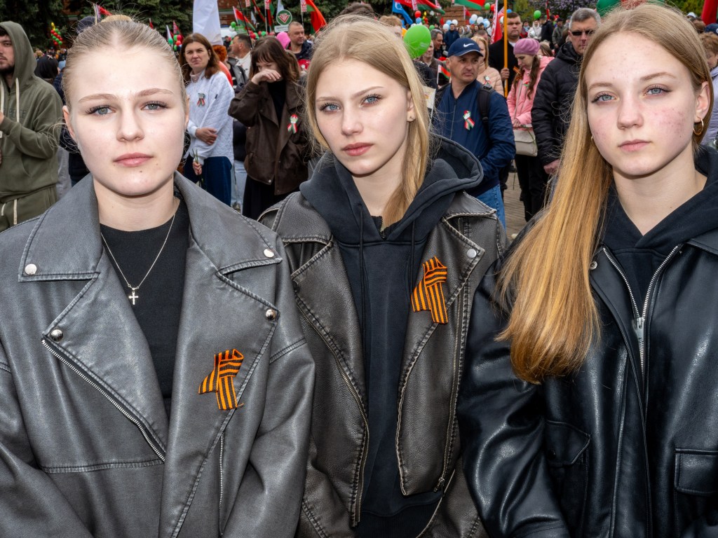 BREST, BELARUS - MAY 9, 2026: Young women wearing the black-and-orange St George’s Ribbon, banned in several Eastern and Northern European countries because of its association with Russian militarism and the war in Ukraine. Image Credit: Peter Dench