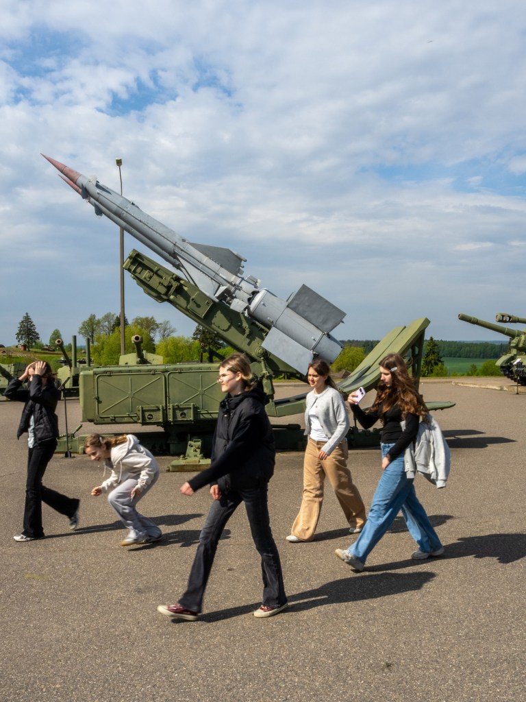 MINSK, BELARUS - MAY 12, 2026: School kids walk among the missiles on display at the Stalin Line historical complex outside Minsk. Image Credit: Peter Dench