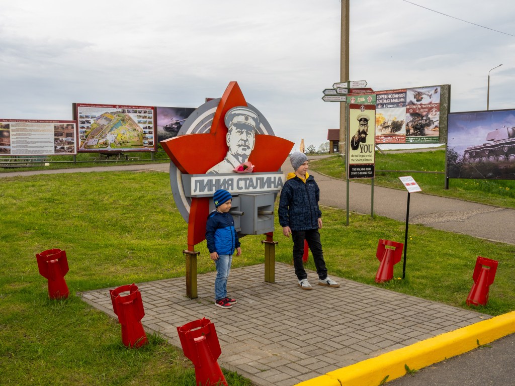 MINSK, BELARUS - MAY 12, 2026: Children pose for a photograph at the entrance to the Stalin Line historical complex outside Minsk. Image Credit: Peter Dench