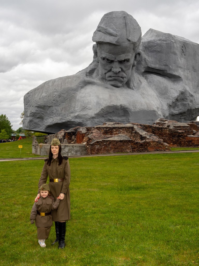 BREST, BELARUS - MAY 9, 2026: Posing for pictures in front of the Courage monument at the memorial complex of the Brest Fortress during Victory Day commemorations marking the Soviet Union's defeat of Nazi Germany in 1945. Image Credit: Peter Dench