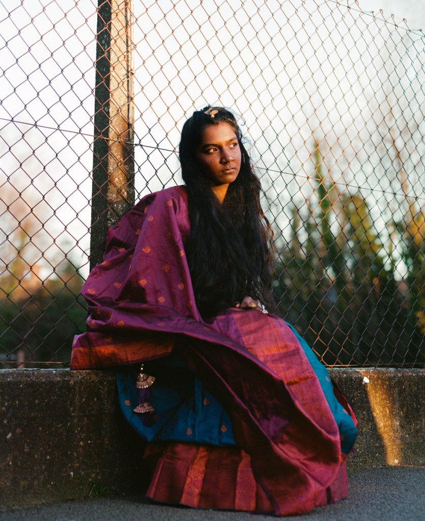 portrait of a girl against fencing