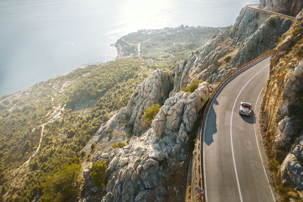 porsche driving along a mountainside