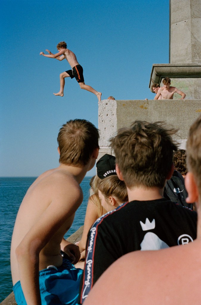 boy jumping into the sea