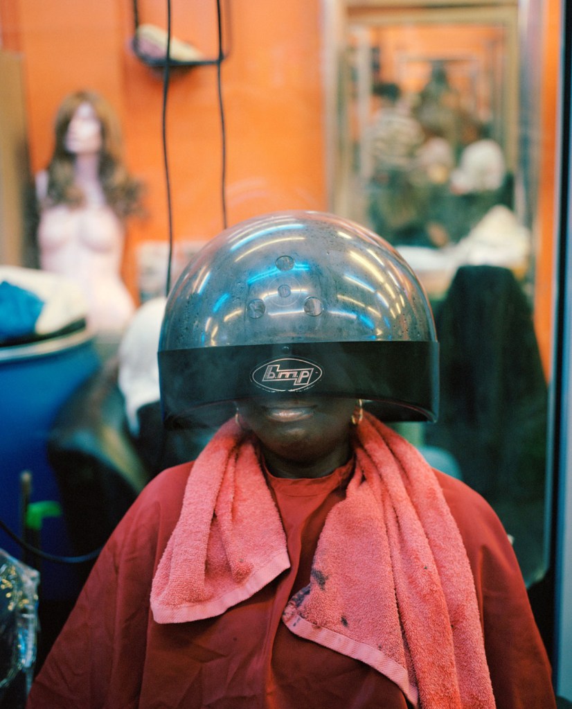 woman with her head in a hair dryer