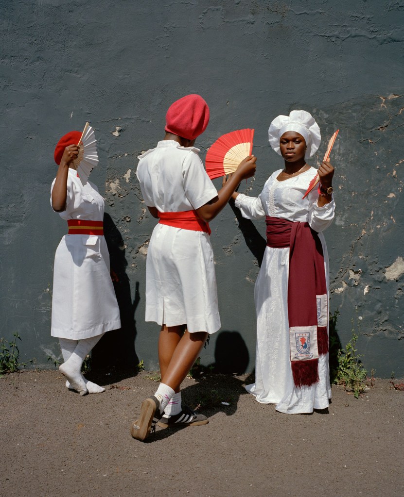 three women in white dresses dancing