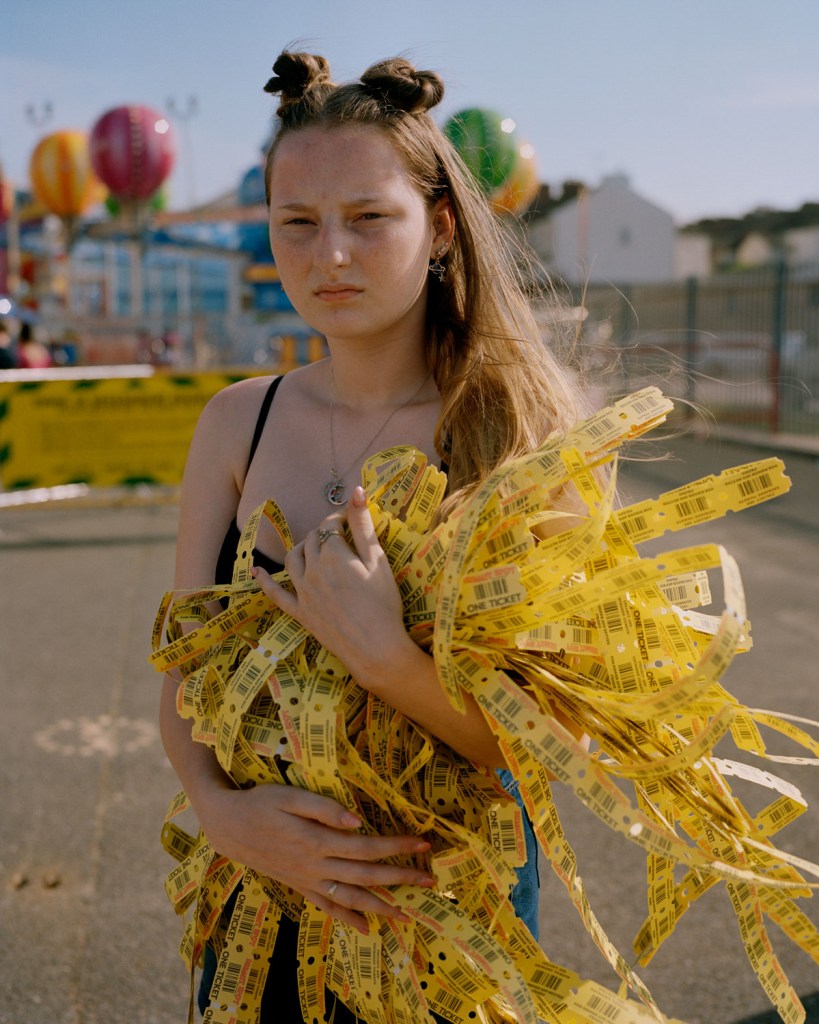 girl holding a stack of tickets