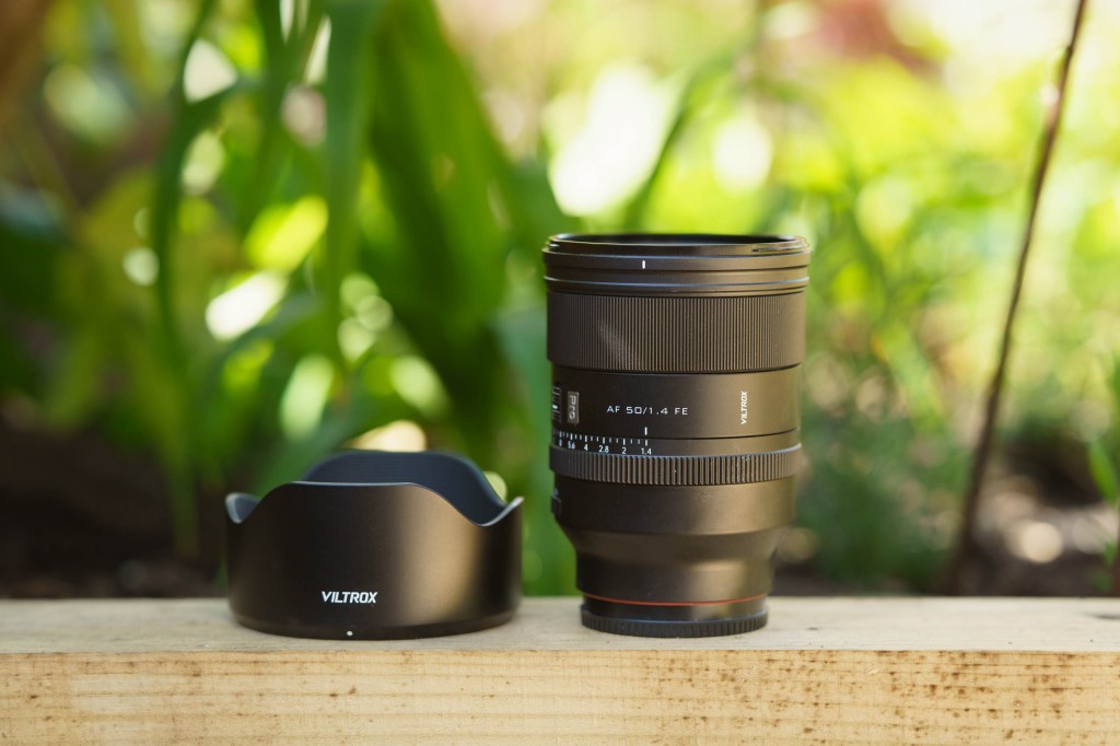 Viltrox 50mm f/1.4 Pro FE side view with lens hood on the side