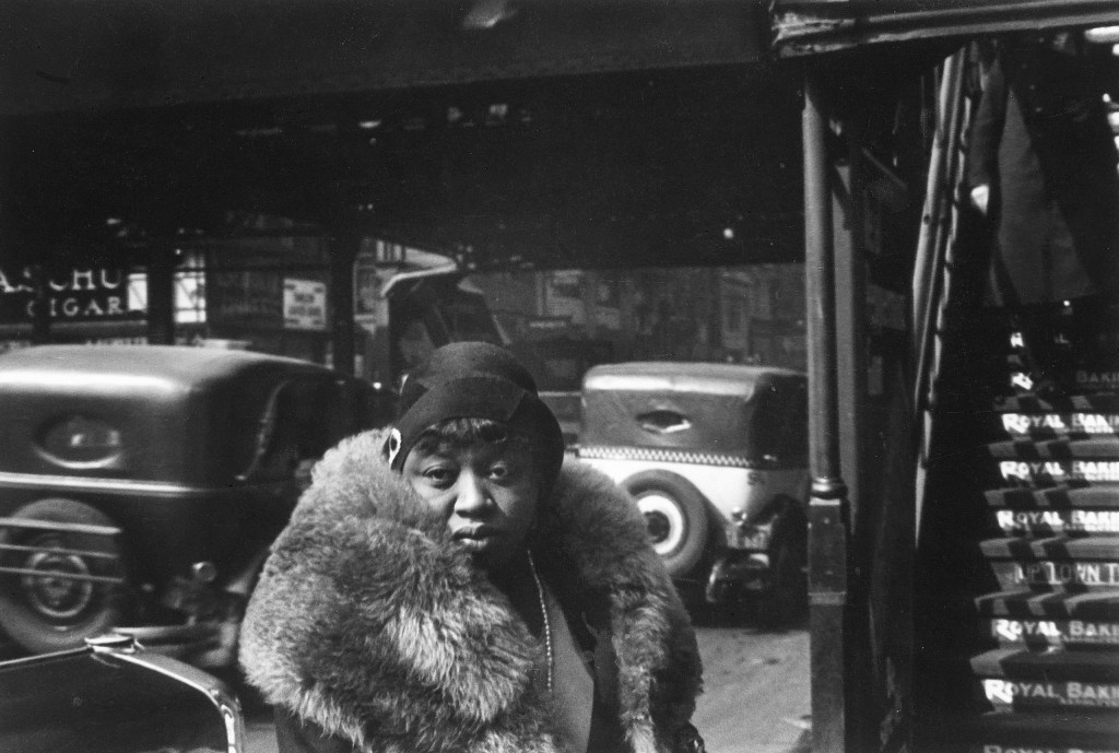 black and white photo of a woman wearing a fur coat