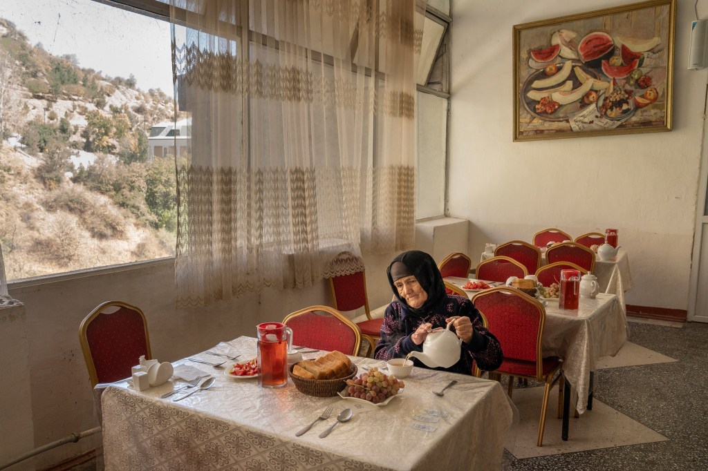 Overall Winner of World Food Photography 2026 Award, Jo Kearney, UK - A Woman Eats in the Canteen of the Soviet-era Sanatorium.
